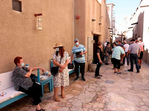 Mask-clad tourists visit the historic Al Fahidi neighbourhood of Dubai.