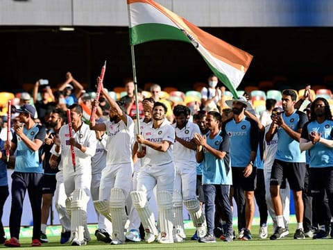 Indian players celebrate after defeating Australia by three wickets on the final day of the fourth cricket test match at the Gabba, Brisbane.