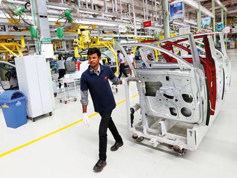 An employee works inside the Mahindra & Mahindra manufacturing plant in Chakan, Maharashtra. India’s auto sector is looking for a rebound as consumer spending returns to growth this year.