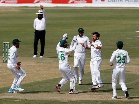 Pakistan's spinner Yasir Shah, second from right, celebrates with teammates on the dismissal of South Africa's Faf du Plessis