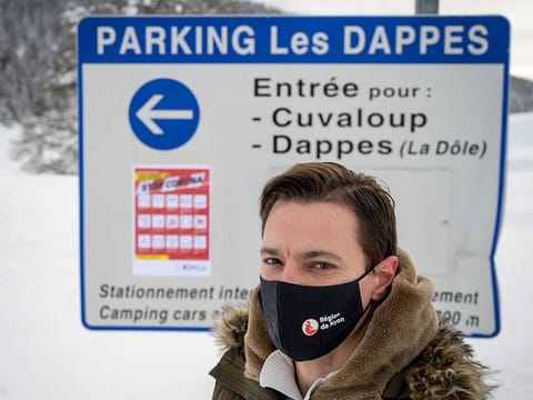 Spokesman of Nyon Region Marco Ferrara poses next to a sign of the closed Dappes Car Park near La Dole.