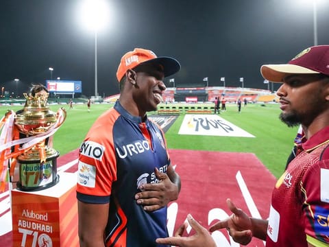 Caribbean flavour: Nicholas Pooran (right), the winning captain of Northern Warriors, has a laugh with Delhi Bulls captain Dwayne Bravo ahead of the Alubond Abu Dhabi T10 final.