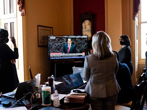 House impeachment managers watch TV as fellow manager Rep. Jamie Raskin explains what it was like to have his daughter at the Capitol during the January 6 riot, as he addresses the first day of the second Senate impeachment trial of former President Donald Trump in Washington on Tuesday, Feb. 9, 2021.