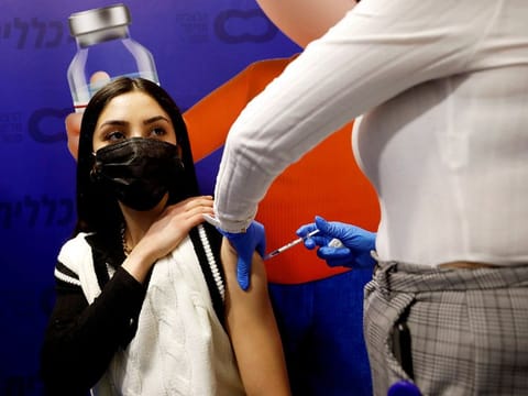A woman receives a vaccination against the COVID-19 at a temporary Clalit Healthcare Maintenance Organisation (HMO) centre, in Herzliya, Israel.