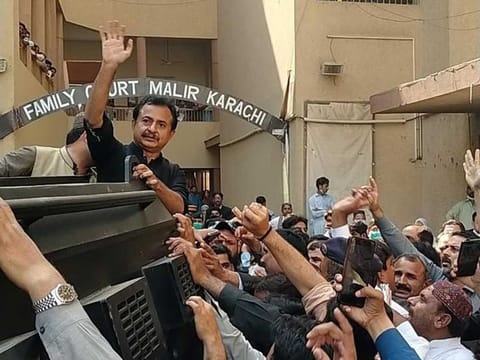 Leader of Opposition in Sindh Assembly, Haleem Adil Shaikh, waves to his supporters as he emerges from an armoured personnel carrier of Sindh Police on his presentation before a court in Karachi on Wednesday, February 17, 2021.