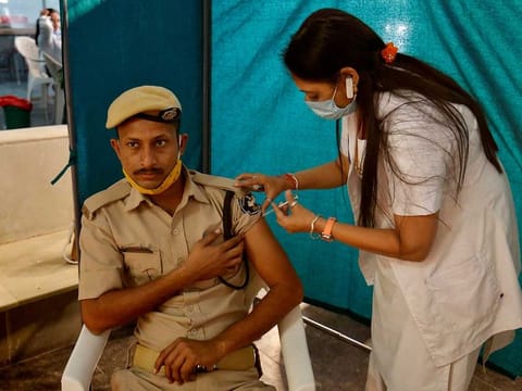 A policeman receives a dose of COVISHIELD, a COVID-19 vaccine manufactured by Serum Institute of India, at a vaccination centre in Ahmedabad, India, February 4, 2021.