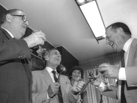 Outgoing Speaker of the Knesset Menachem Savidor passes the gavel to Shlomo Hillel as acting Speaker Abba Eban looks on.