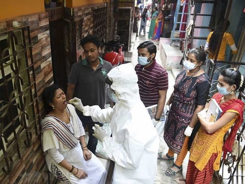 A health worker collects swab samples of residents of Dharavi during a door-to-door screening for COVID-19, in Mumbai, Thursday, March 11, 2021.