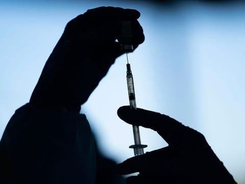 A medical staff member prepares the Pfizer COVID-19 vaccine at Tudor Ranch in Mecca, California.