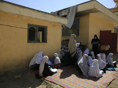 In this October 7, 2020 file picture, Afghan students attend an open air class at a primary school in Kabul. An Afghan education ministry memo banning girls, 12 years old and older, from singing at public school functions, which the education ministry said was a mistake, is causing a social media stir.