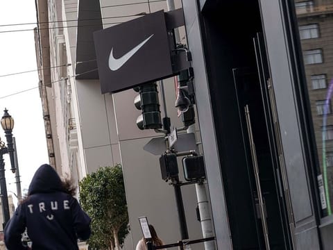 A pedestrian walks in front of a Nike Inc. store in San Francisco on March 15, 2021.