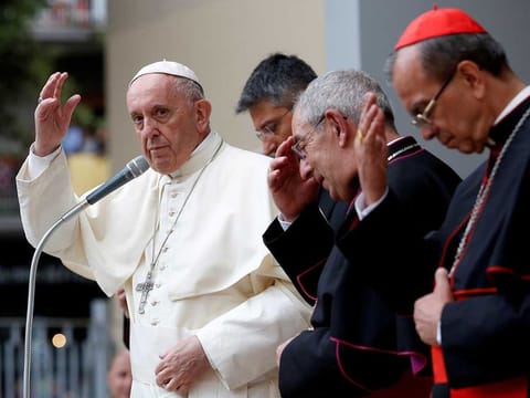 Pope Francis gives a blessing as he leaves after his visit to the Roman parish of the Santissimo Sacramento on the outskirts of Rome, Italy, May 6, 2018.