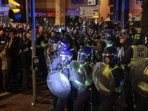 Police officers hold their shields as demonstrators take part in a protest against a newly proposed policing bill, in Bristol, Britain.