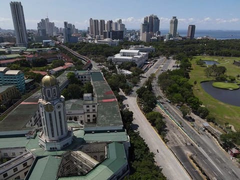 The Manila City Hall (foreground left). The Philippines, however, is not Manila alone — it is mountains and islands, farms and fishing towns, 7,641 stories wider than the capital’s skyline.