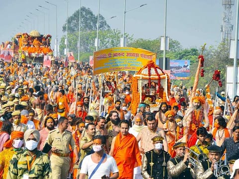 Pilgrims on their way to take a holy dip at Har ki Pauri during Kumbh, in Haridwar on Wednesday, April 14, 2021.