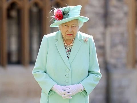 In this file photo taken on July 17, 2020 Britain's Queen Elizabeth II poses after confering the honour of a knighthood upon 100-year-old veteran Captain Tom Moore during an investiture at Windsor Castle in Windsor, west of London. - Elizabeth II celebrates her 95th birthday on Wednesday, April 21, four days after having buried her husband of 73 years, Prince Philip, whom she described as her great "support".