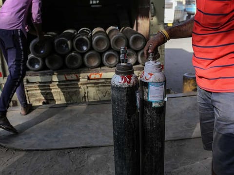 File picture: Workers load refilled oxygen tanks into a vehicle at a refill station in Navi Mumbai, India, on Thursday, April 22, 2021.