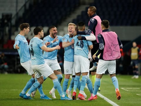 Manchester City's Riyad Mahrez celebrates scoring their second goal with teammates.