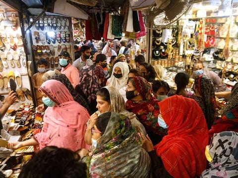 Women shop for the upcoming Eid Al Fitr holiday that marks the end of Ramadan, at a market in Lahore, Pakistan, Thursday, May 6, 2021.
