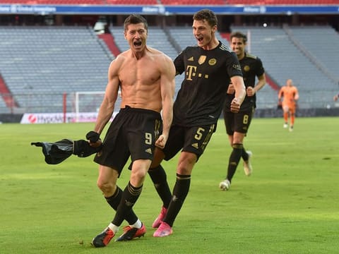 Bayern Munich's Polish forward Robert Lewandowski celebrates scoring his team's fifth goal and his 41st season goal against Augsburg