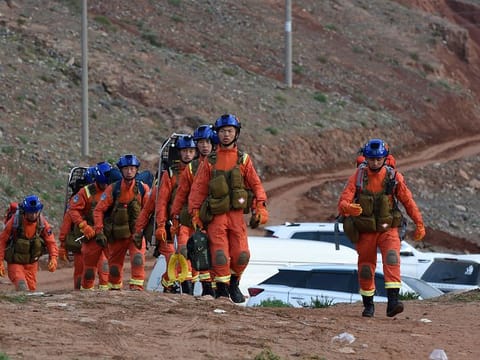 Rescuers walk into the accident site to search for mountain marathon survivors in Jingtai County of Baiyin City, northwest China's Gansu Province