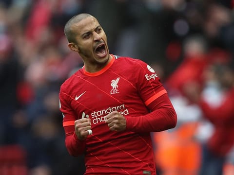 Liverpool's Thiago Alcantara celebrates after winning the match and qualifying for the UEFA Champions League.