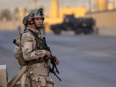 Iraqi Army soldiers stand guard on a road between the US Embassy and the International Zone on May 30, 2021 in Baghdad, Iraq.