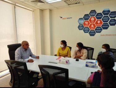 Dr Sanjay Paithankar interacts with a group of stranded nurses from Kerala in the UAE.