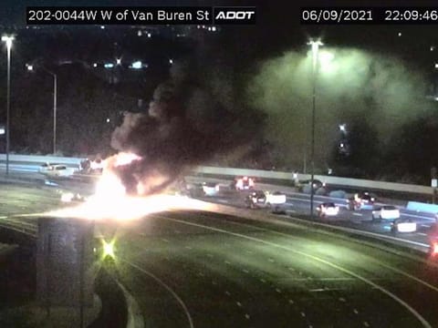 This image from an Arizona Department of Transportation remote traffic camera shows the scene of a crash involving a milk tanker truck in Phoenix on Wednesday, June 9, 2021.
