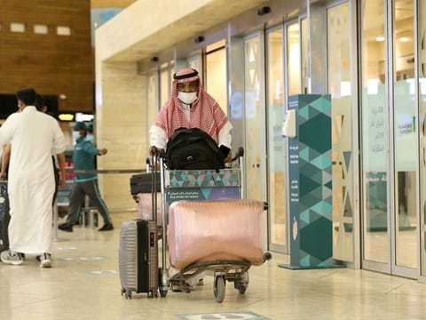 Saudi passengers arrive at King Khaled International airport in the capital Riyadh in this file photo.