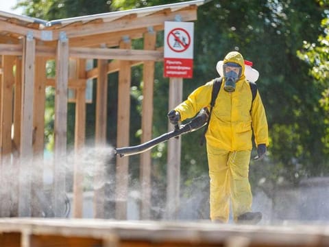 A specialist wearing personal protective equipment (PPE) sprays disinfectant while sanitizing the Rizhsky Railway Station, one of the measures to curb the spread of COVID-19, in Moscow.