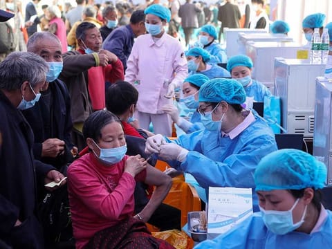This file photo taken on April 12, 2021 shows people receiving the China National Biotec Group (CNBG) COVID-19 coronavirus vaccine in China's southwestern Chongqing. China has now administered more than a billion doses of vaccines, the country's health authority said on June 20, 2021, more than a third of the number given worldwide.