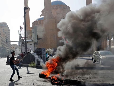 Demonstrators burn tires to block the Martyrs' Square in the centre of Lebanon's capital Beirut on June 26, 2021, as they protest against dire living conditions amidst the ongoing economical and political crisis.