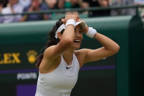 Britain's Emma Raducanu celebrates winning her women's singles third round match against Romania's Sorana Cirstea on day six of the Wimbledon Tennis Championships in London.