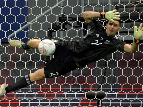 Unlikely hero: Argentina's goalkeeper Emiliano Martinez stops the shot by Colombia's Yerry Mina, one of his three saves, during the shootout of their Copa America semi-final match at the Mane Garrincha Stadium in Brasilia, on Wednesday.