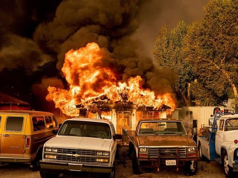 Flames consume a home as the Sugar Fire, part of the Beckwourth Complex Fire, tears through Doyle, Calif., on Saturday, July 10, 2021. Pushed by heavy winds amid a heat wave, the fire came out of the hills and destroyed multiple residences in central Doyle.