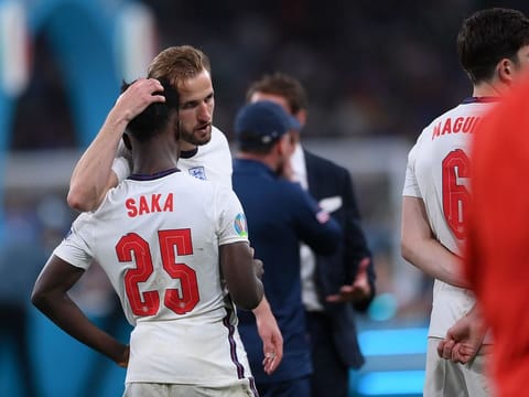 England's Harry Kane consoles Bukayo Saka after the penalty shootout against Italy in the Euro 2020 final.