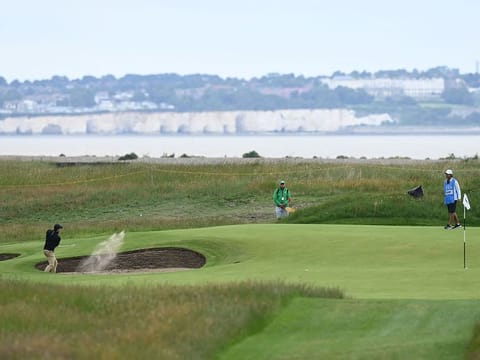 Rory McIlroy plays out of a green-side bunker during a practice round for The Open