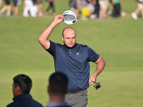 England's Jonathan Thomson waves to fans at The Open