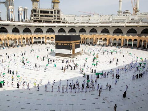 Pilgrims keeping social distance perform Umrah in the Grand Mosque in the holy city of Mecca, Saudi Arabia, July 17, 2021.