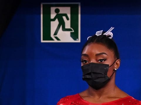 Simone Biles of the United States is seen leaving a medical station during the gymnastics team event final in Tokyo on Tuesday.