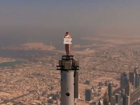 American skydiver and stuntwoman Nicole Smith-Ludvik in a daring advertisement playing as an Emirates flight attendant standing on top of the world’s tallest building Burj Khalifa in Dubai.