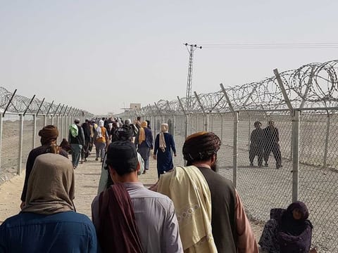 People arriving from Afghanistan make their way at the Friendship Gate crossing point at the Pakistan-Afghanistan border town of Chaman, Pakistan August 15, 2021.