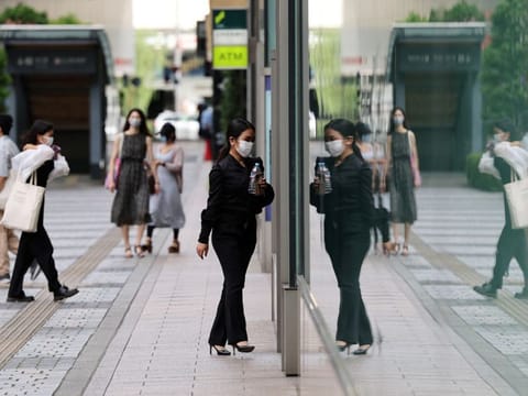 People make their way at a shopping district in Tokyo, Japan, on August 25, 2021.