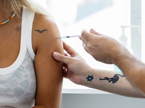An Israeli woman receives a third shot of COVID-19 vaccine in Tel Aviv.