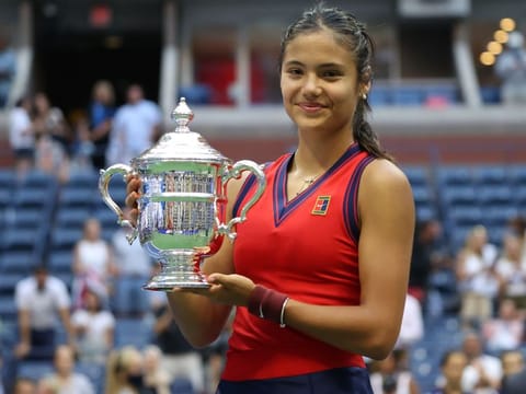 Emma Raducanu of Great Britain celebrates with the US Open trophy after defeating Leylah Annie Fernandez of Canada in the final at the USTA Billie Jean King National Tennis Center in New York City.