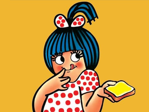 The Amul girl is the famous mascot dressed in a polka dotted frock with blue hair and a half pony tail