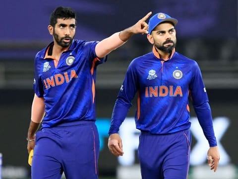 India's Jasprit Bumrah (left) gestures as captain Virat Kohli watches during the ICC Men’s Twenty20 World Cup cricket match against New Zealand at the Dubai International Cricket Stadium on October 31, 2021.
