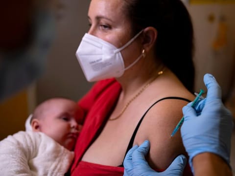 A doctor administers a vaccine to a woman in Berlin on November 2, 2021. Germany added 20,398 cases over the past 24 hours, the Robert Koch health institute said Wednesday, while another 194 people died.