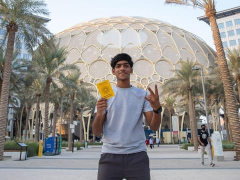 Fazil Ummer with his Expo passport that has stamps from visiting all Expo country pavilions in three days